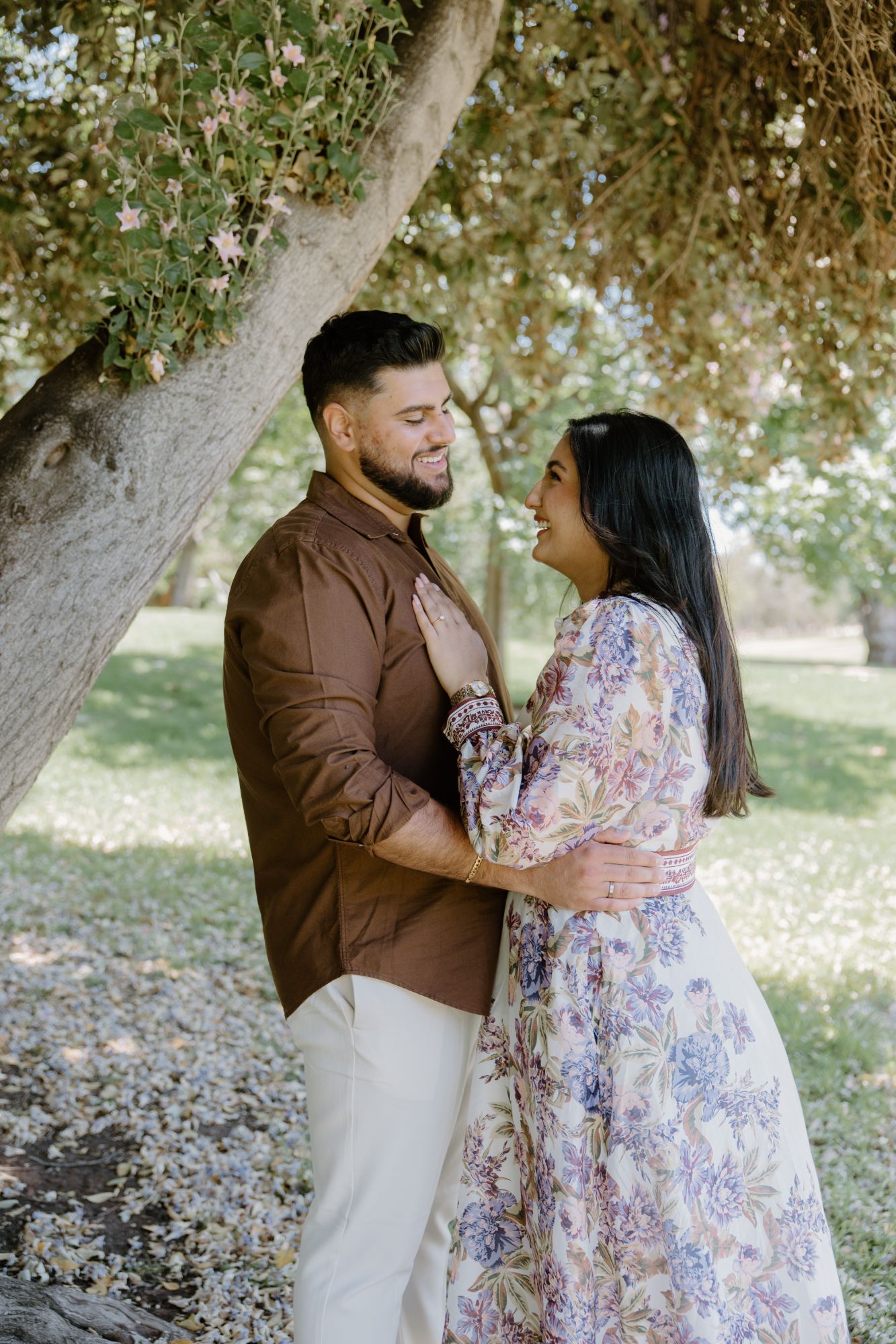 Couple laughing together under a tree