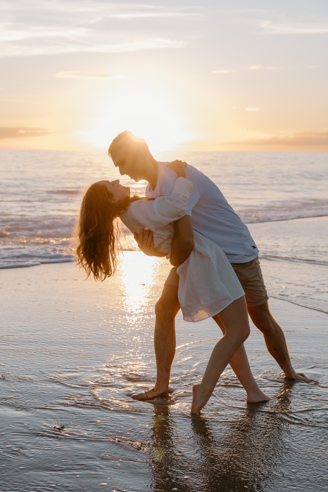 A dip in the shallows with the sun setting behind them