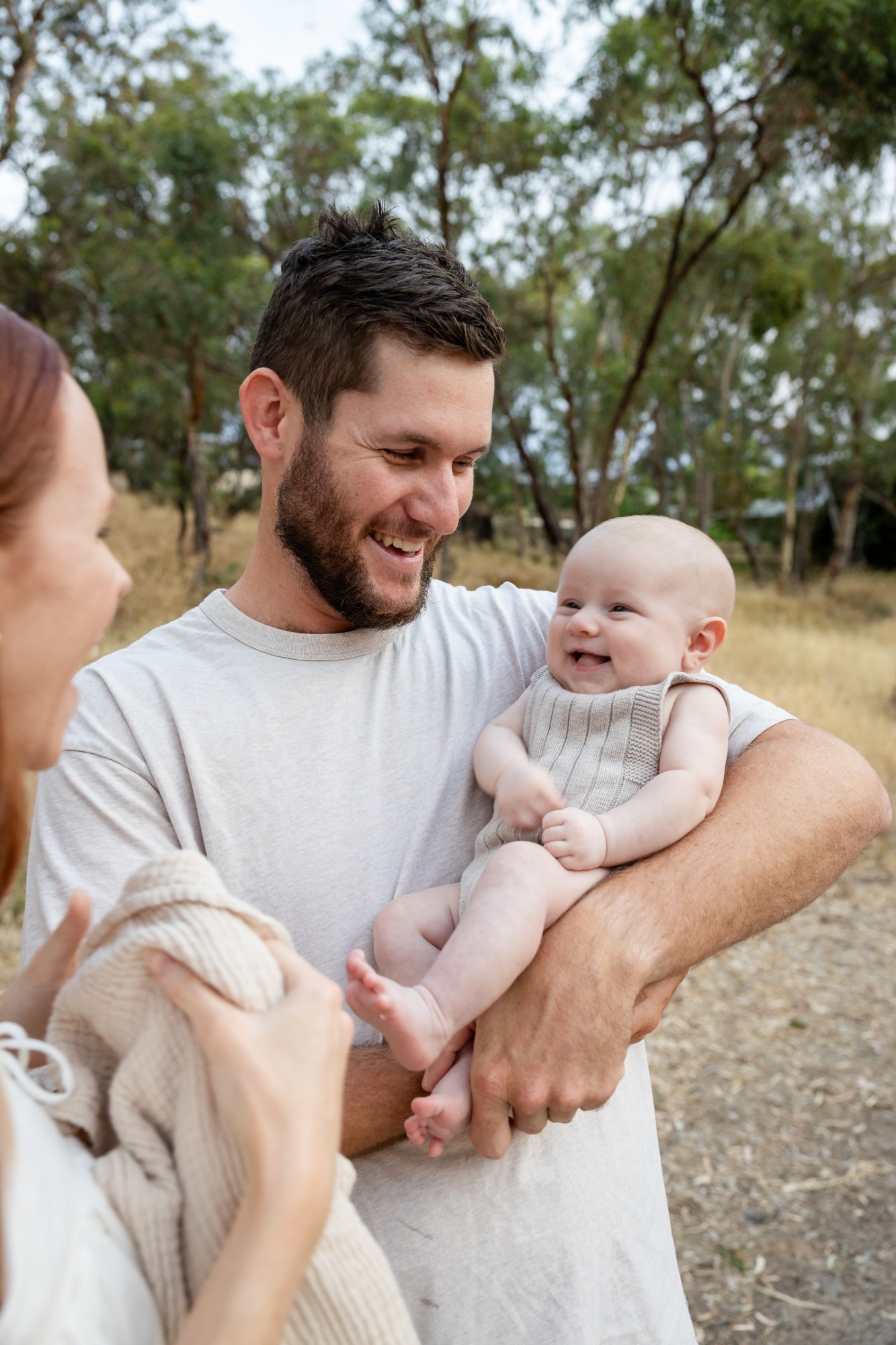 Father smiling at the baby in his arms