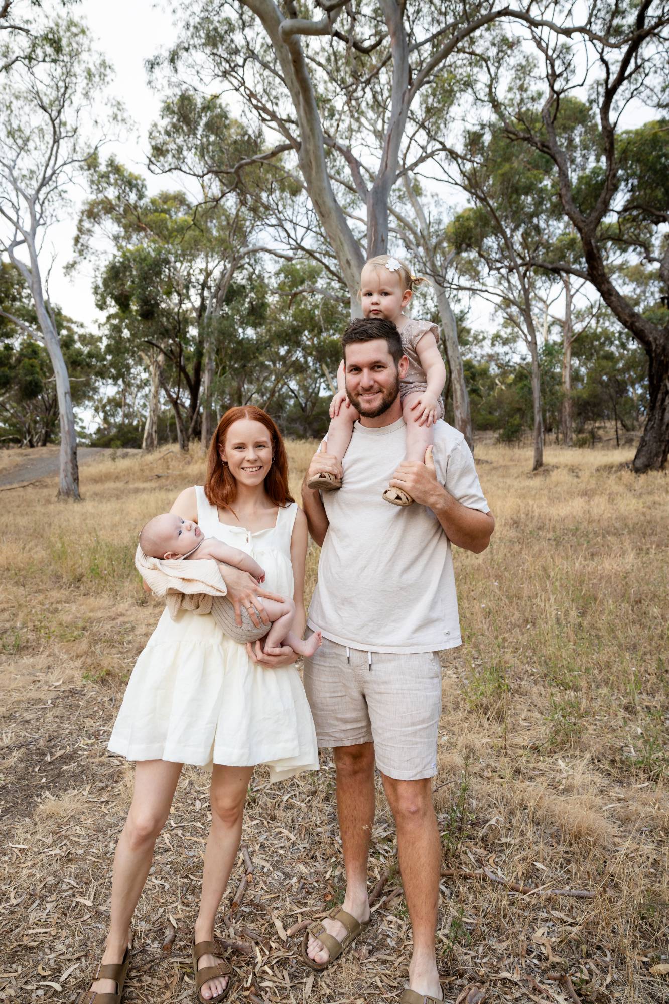 Family walking along a gravel track among gum trees